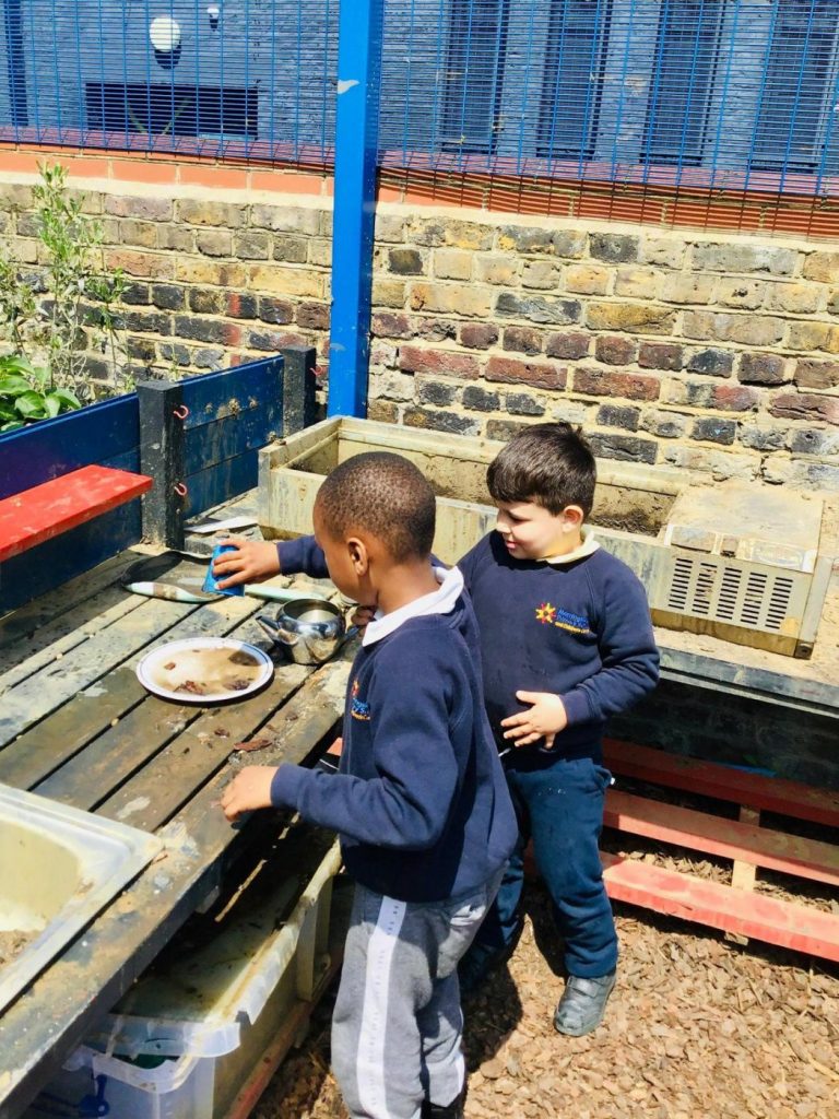 Children playing in the mud kitchen.